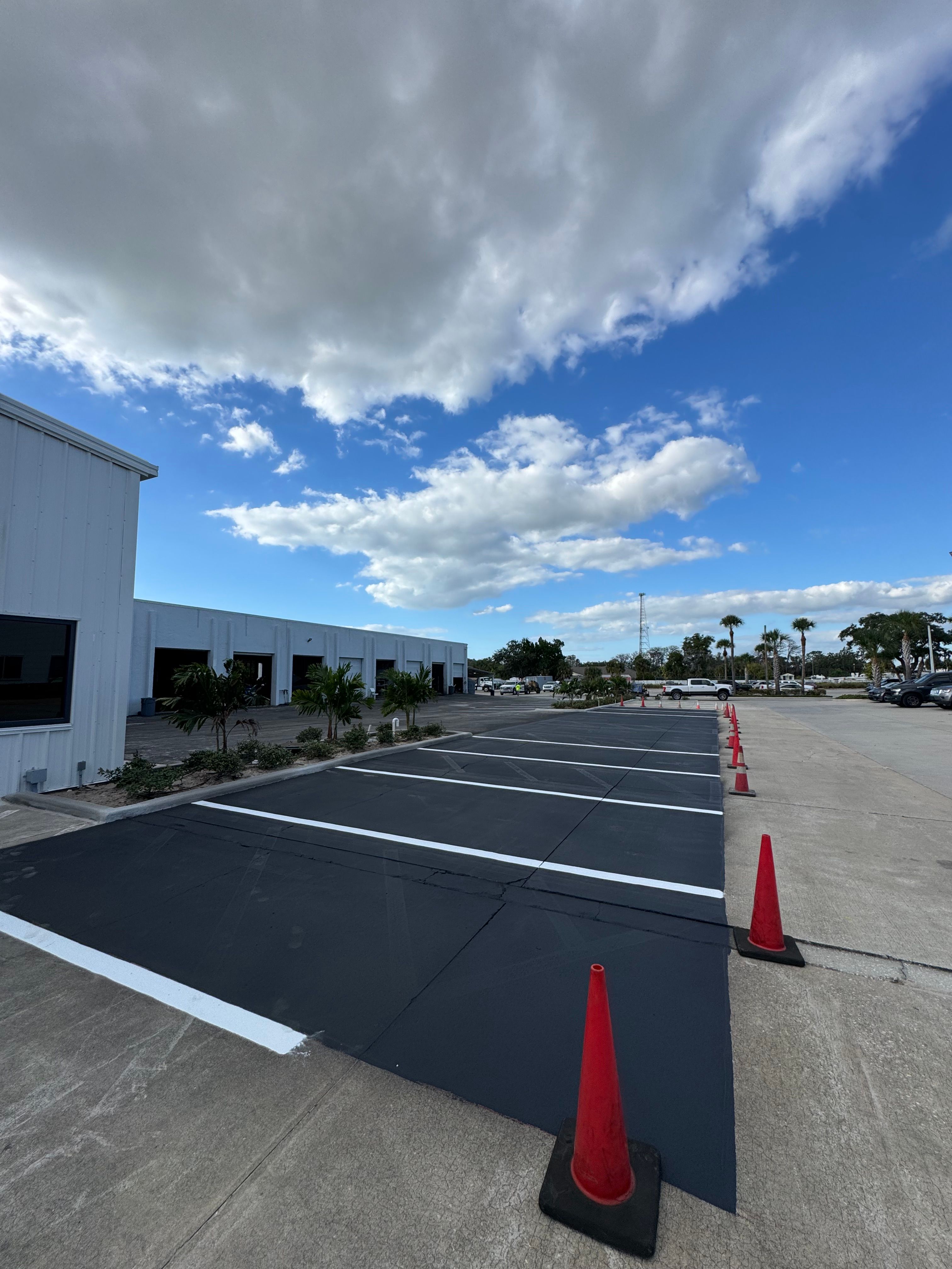 Fresh parking-space striping at an industrial warehouse