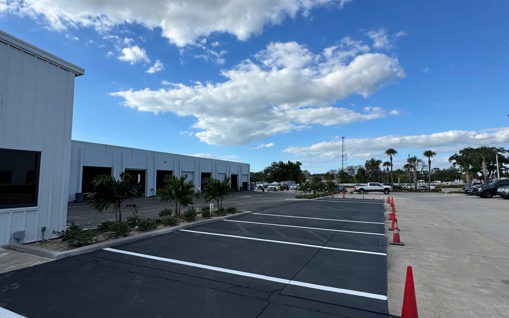 Fresh parking-space striping at an industrial warehouse