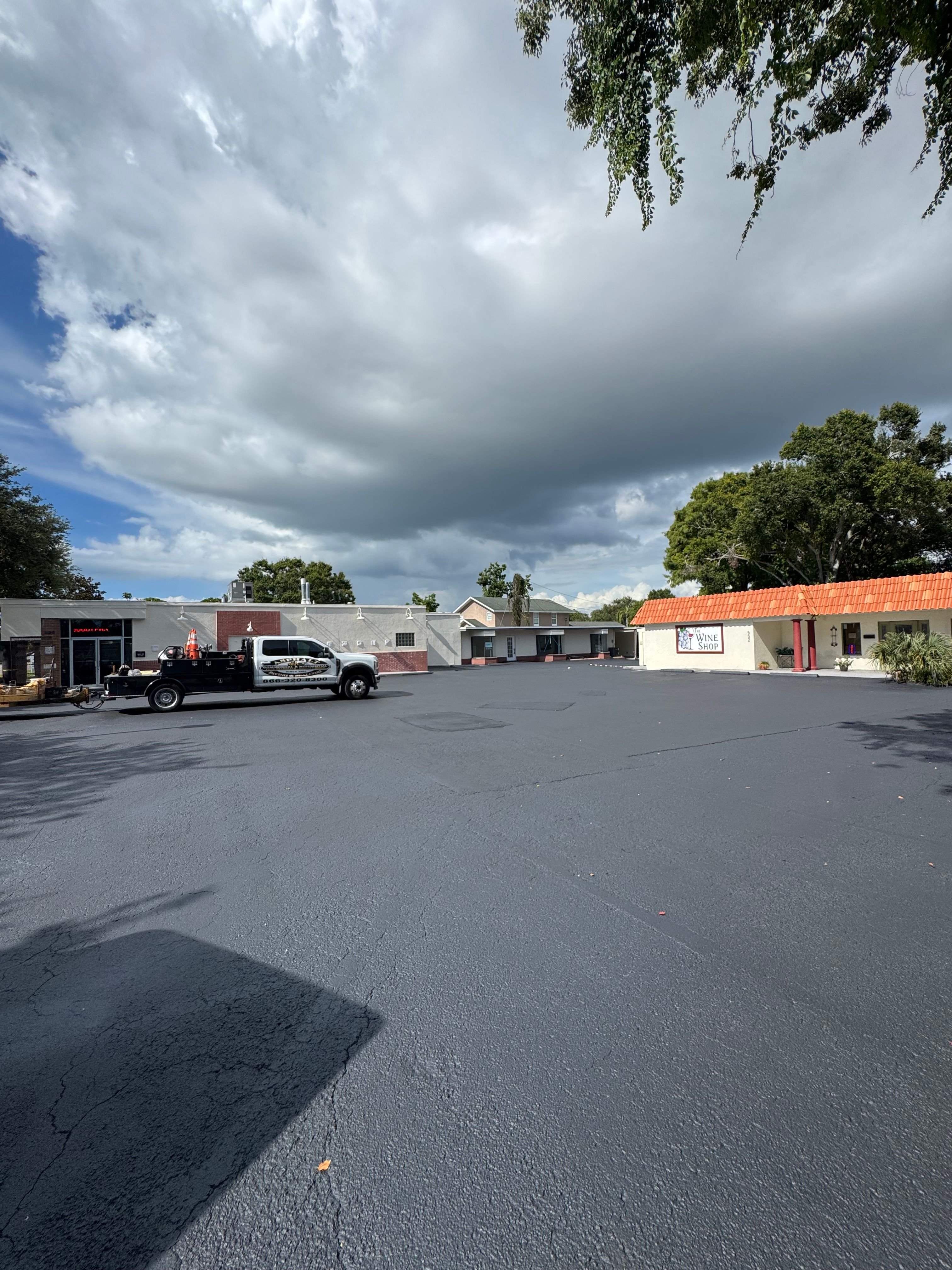 Completed asphalt and parking layout at a commercial plaza