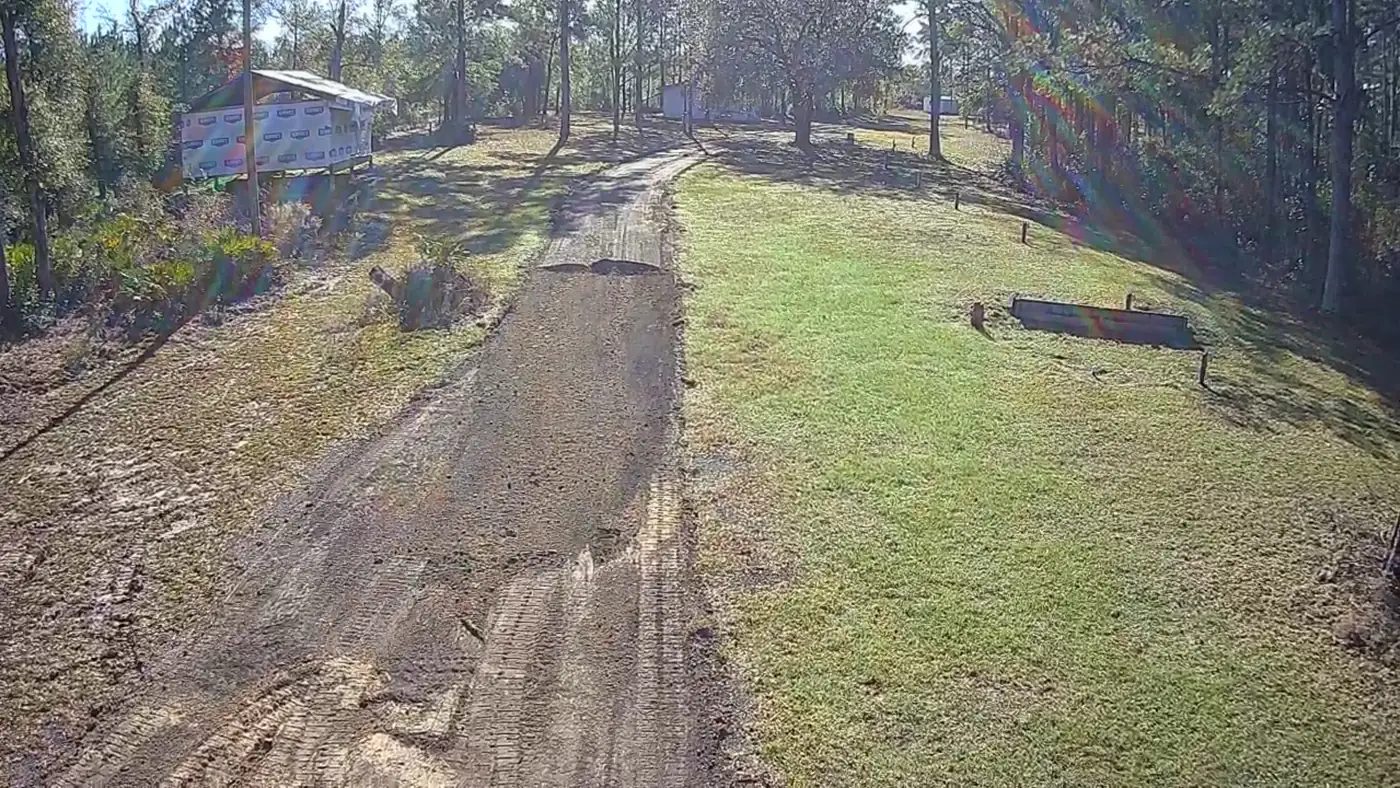 Aerial view of grading and base preparation along a private driveway
