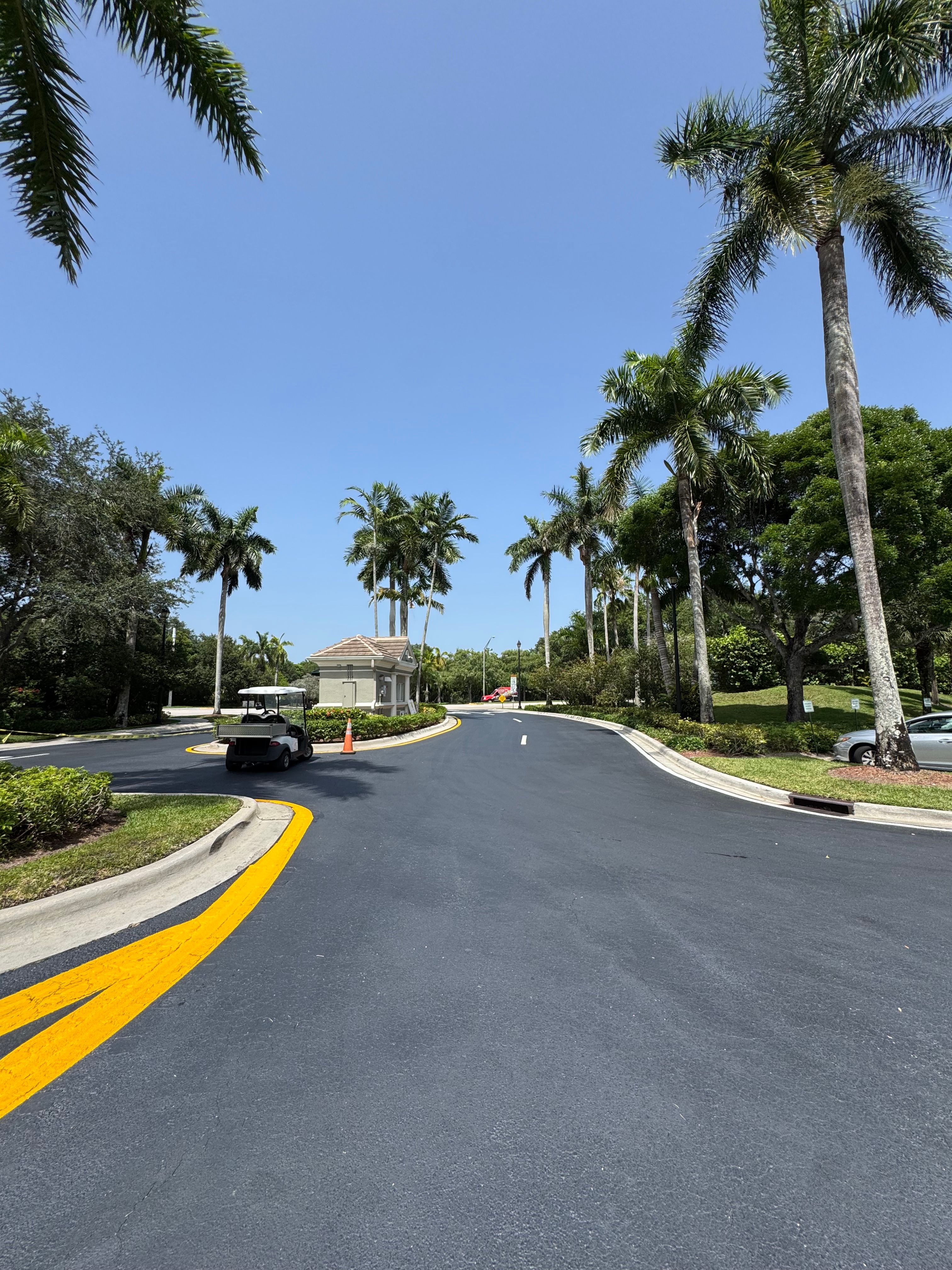 Completed curved asphalt road with yellow centerline markings
