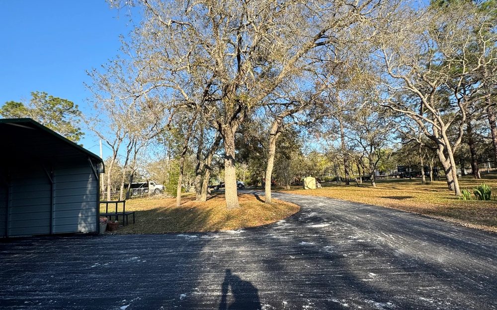 Surfaced residential driveway leading to a detached garage
