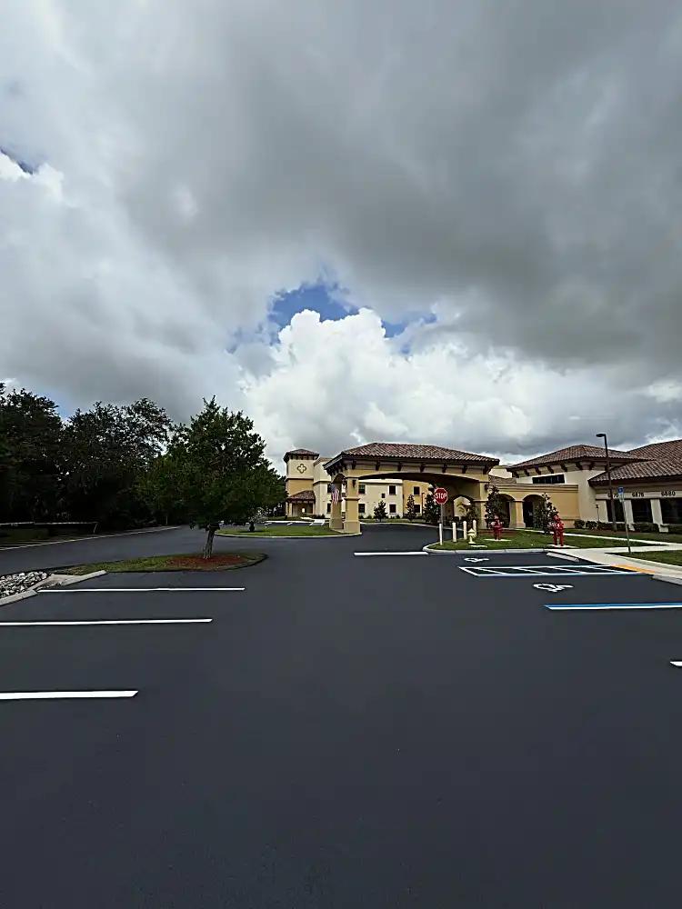 Fort Myers parking lot entrance with fresh sealcoating and striping