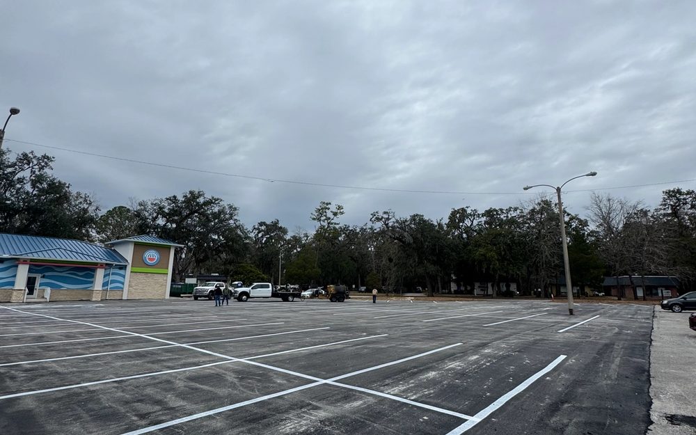 Fresh white parking-space striping on a commercial asphalt lot