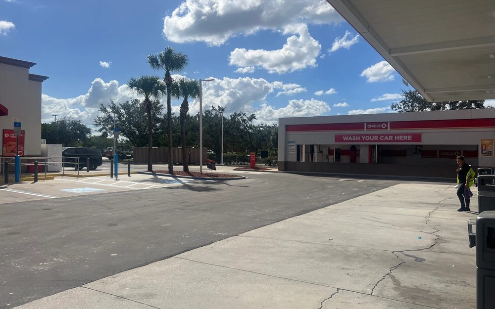 Asphalt pavement work beside a Circle K store and car wash