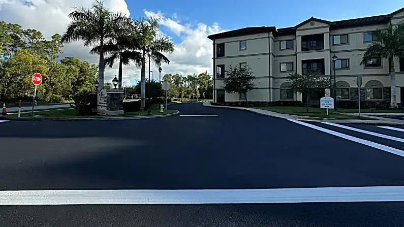 Discovery Village at Naples entrance with dark sealcoat and fresh white traffic markings