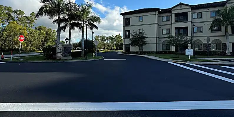 Discovery Village at Naples entrance with dark sealcoat and fresh white traffic markings