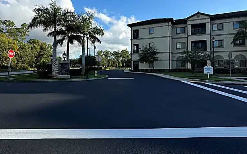 Discovery Village at Naples entrance with dark sealcoat and fresh white traffic markings