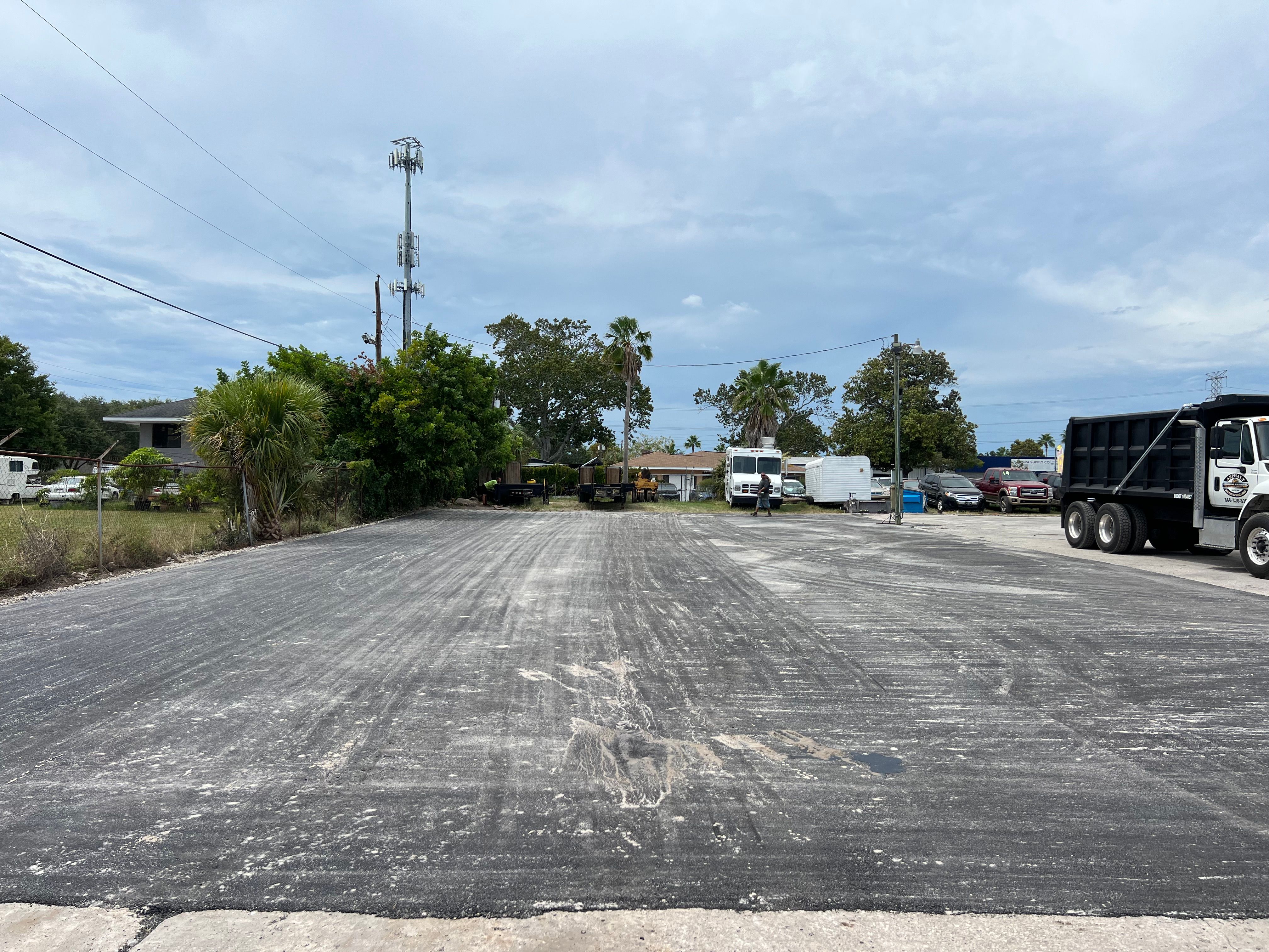 Prepared industrial parking area with work trucks on site