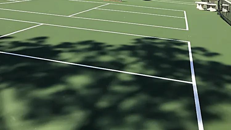 Resurfaced tennis courts with fresh white game lines