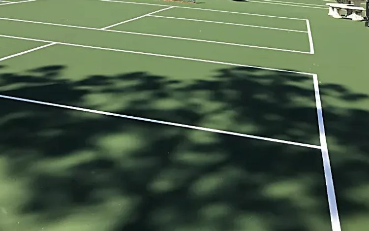 Resurfaced tennis courts with fresh white game lines