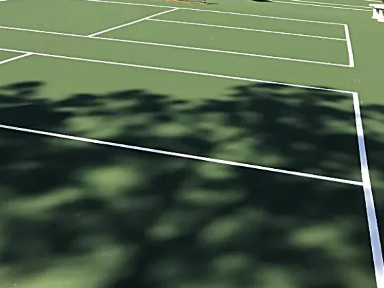 Resurfaced tennis courts with fresh white game lines