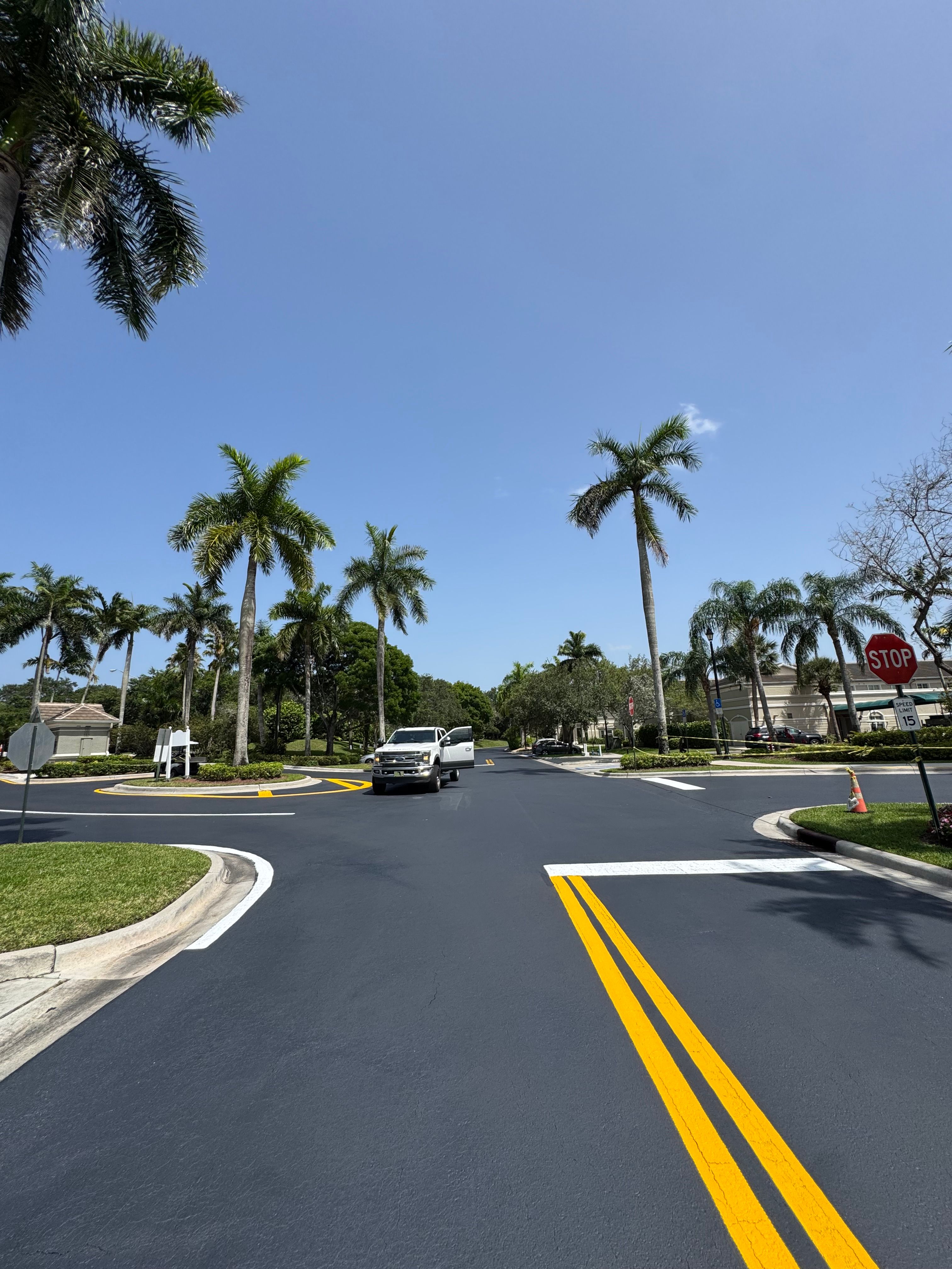Fresh centerline striping on a newly surfaced community roadway