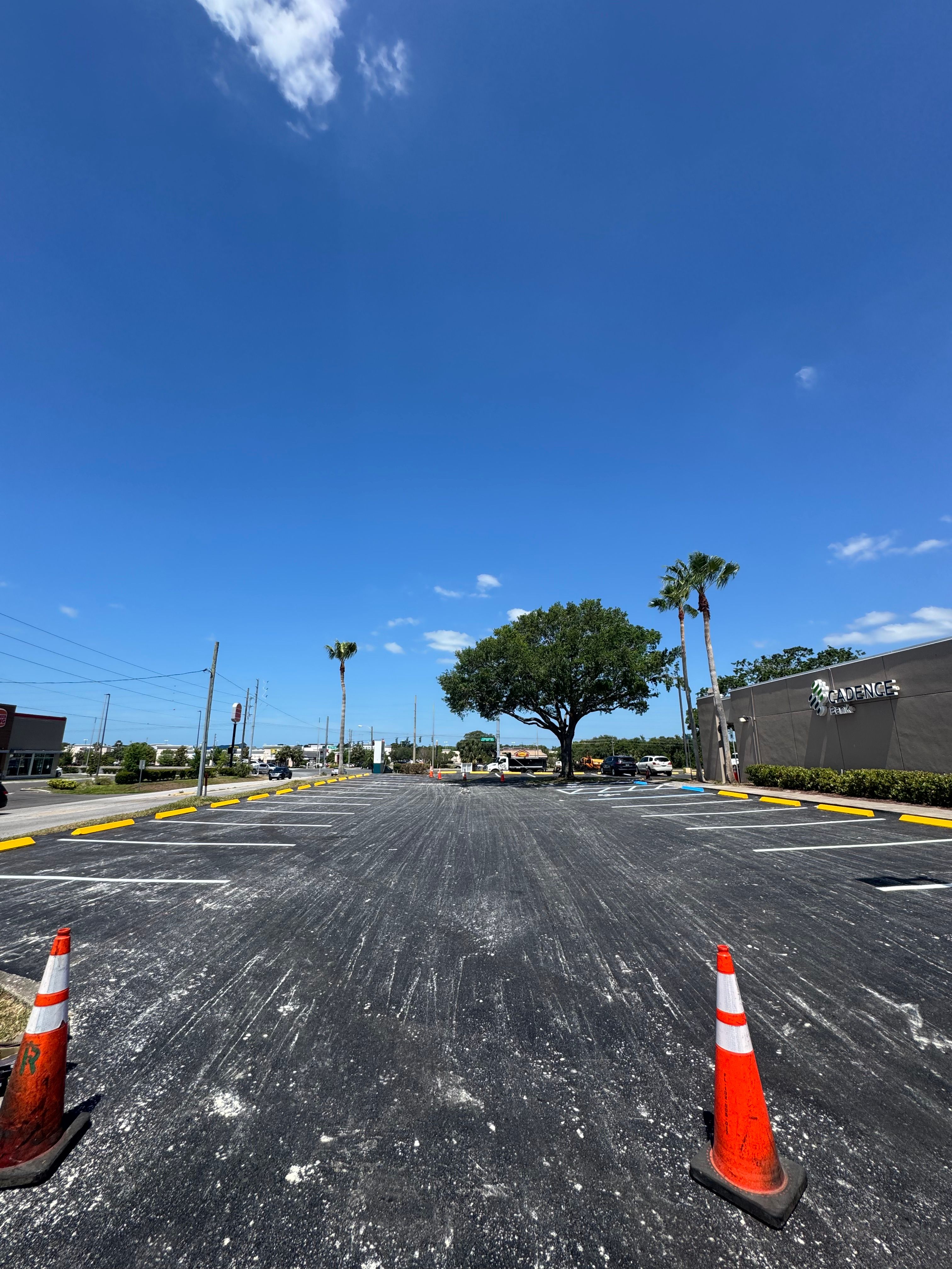 Restriped commercial parking area with yellow wheel stops