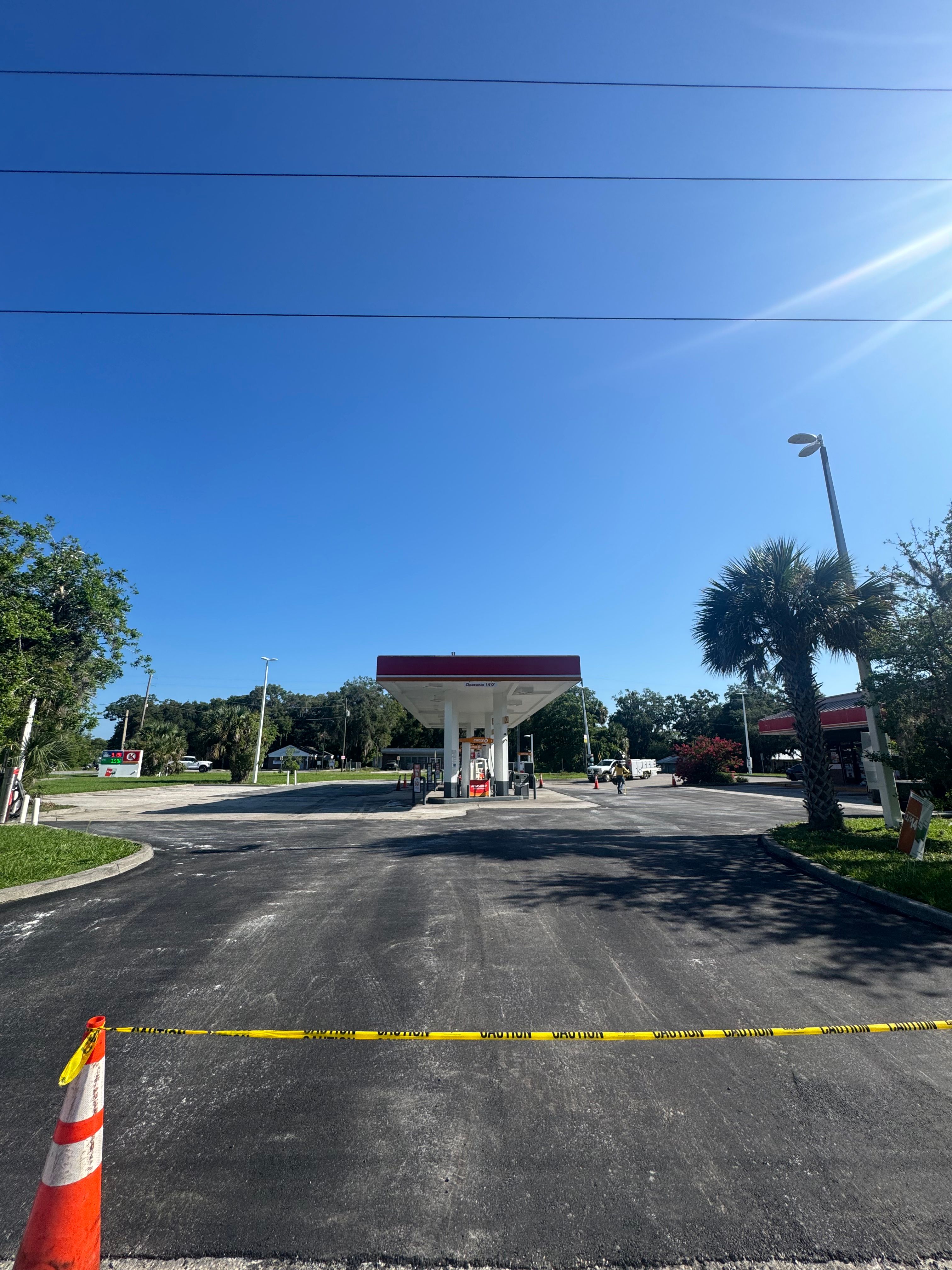 Wide view of asphalt work at a convenience-store property