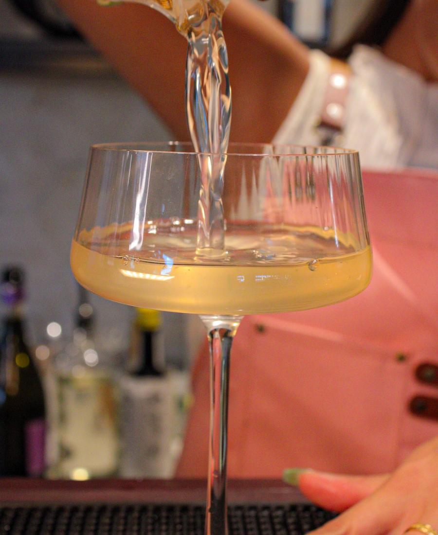 Styled cocktail with floral garnish on a luxury mobile bartending setup