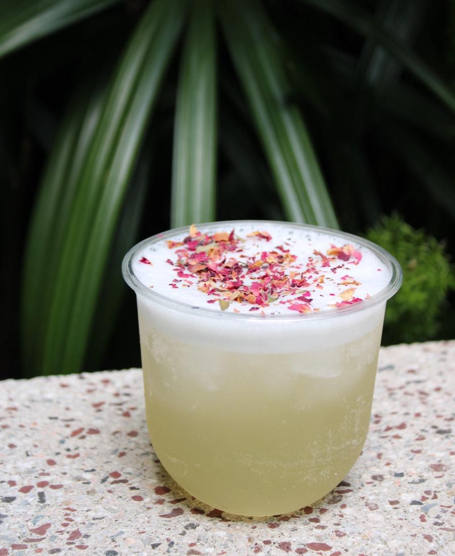 Styled cocktail with floral garnish on a luxury mobile bartending setup