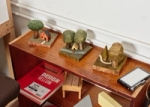 Carved and painted trees and dwellings.