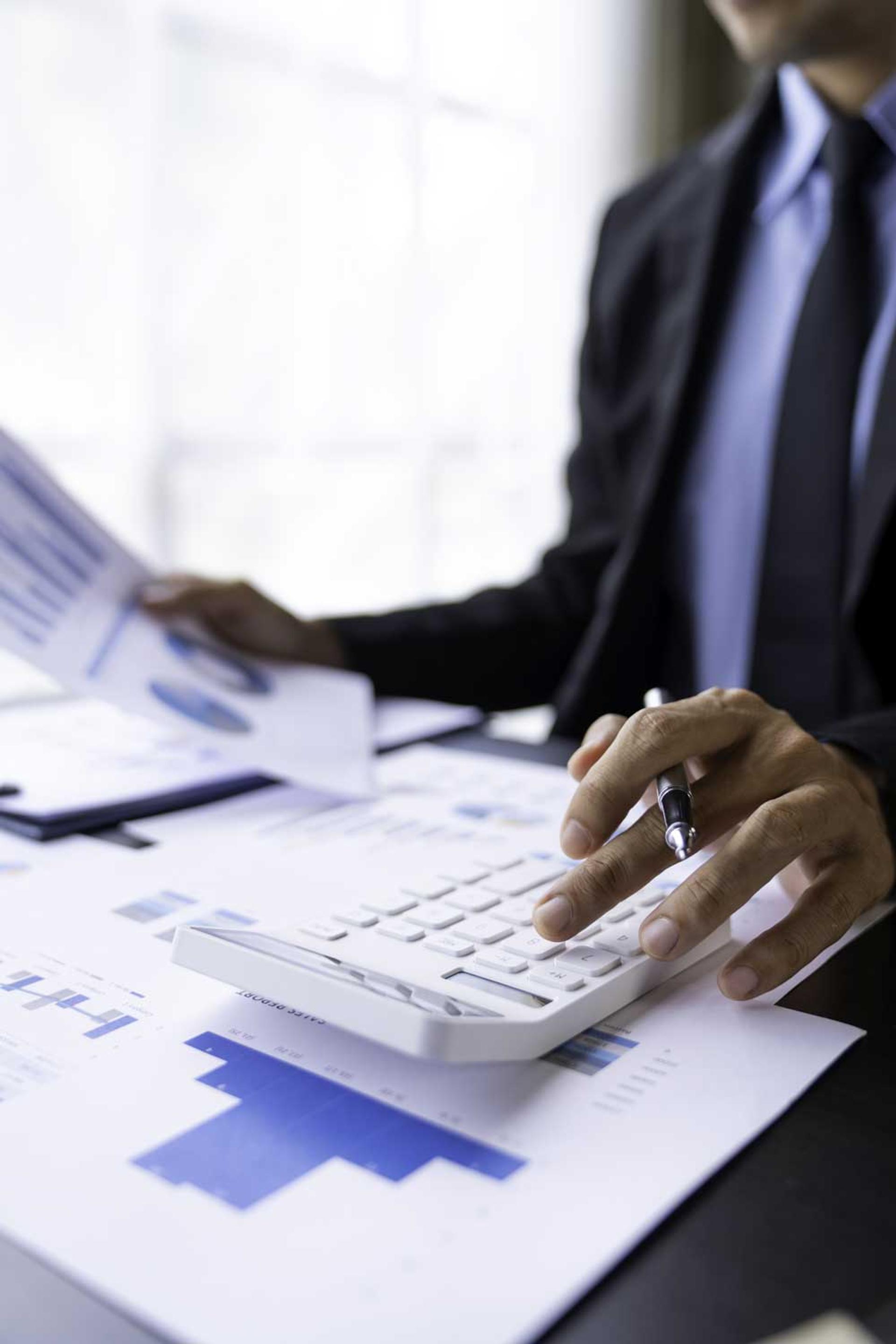 asian-male-finance-staff-is-calculating-by-using-a-2023-11-27-05-20-18-utc