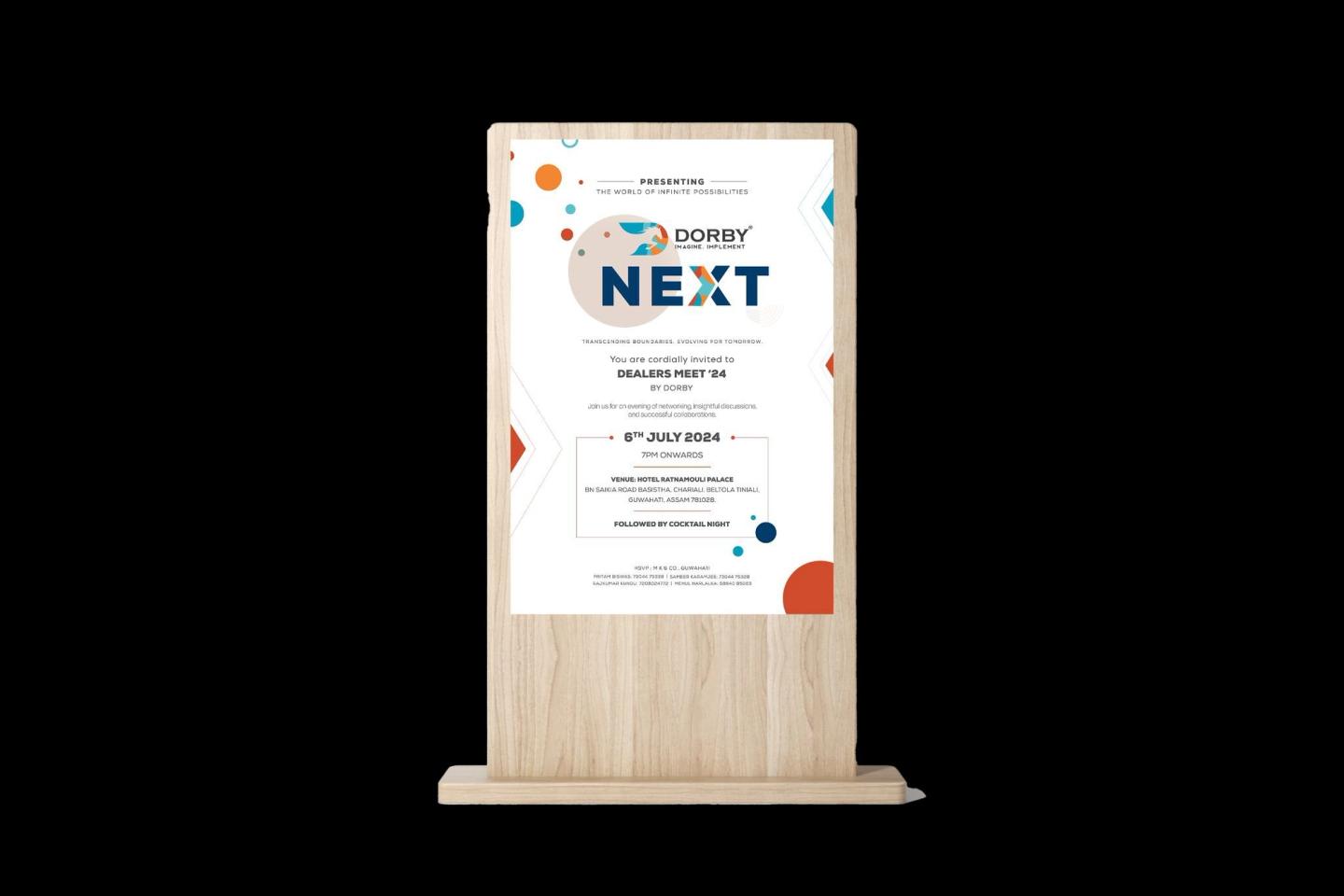 A table standee for Dorby NEXT on a wooden base