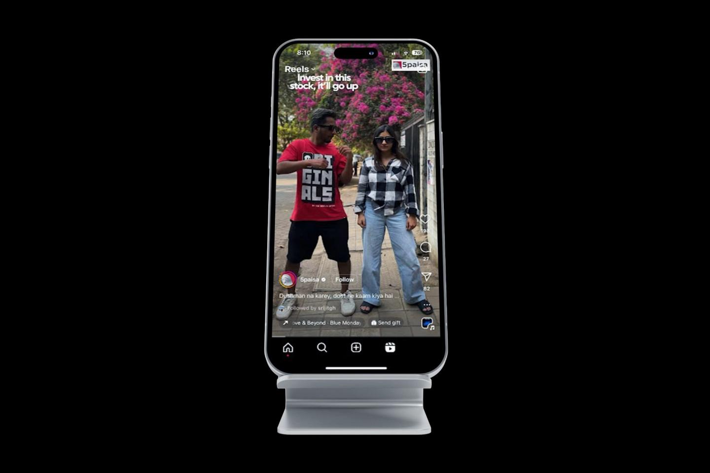 A phone on a stand showing a trends reel