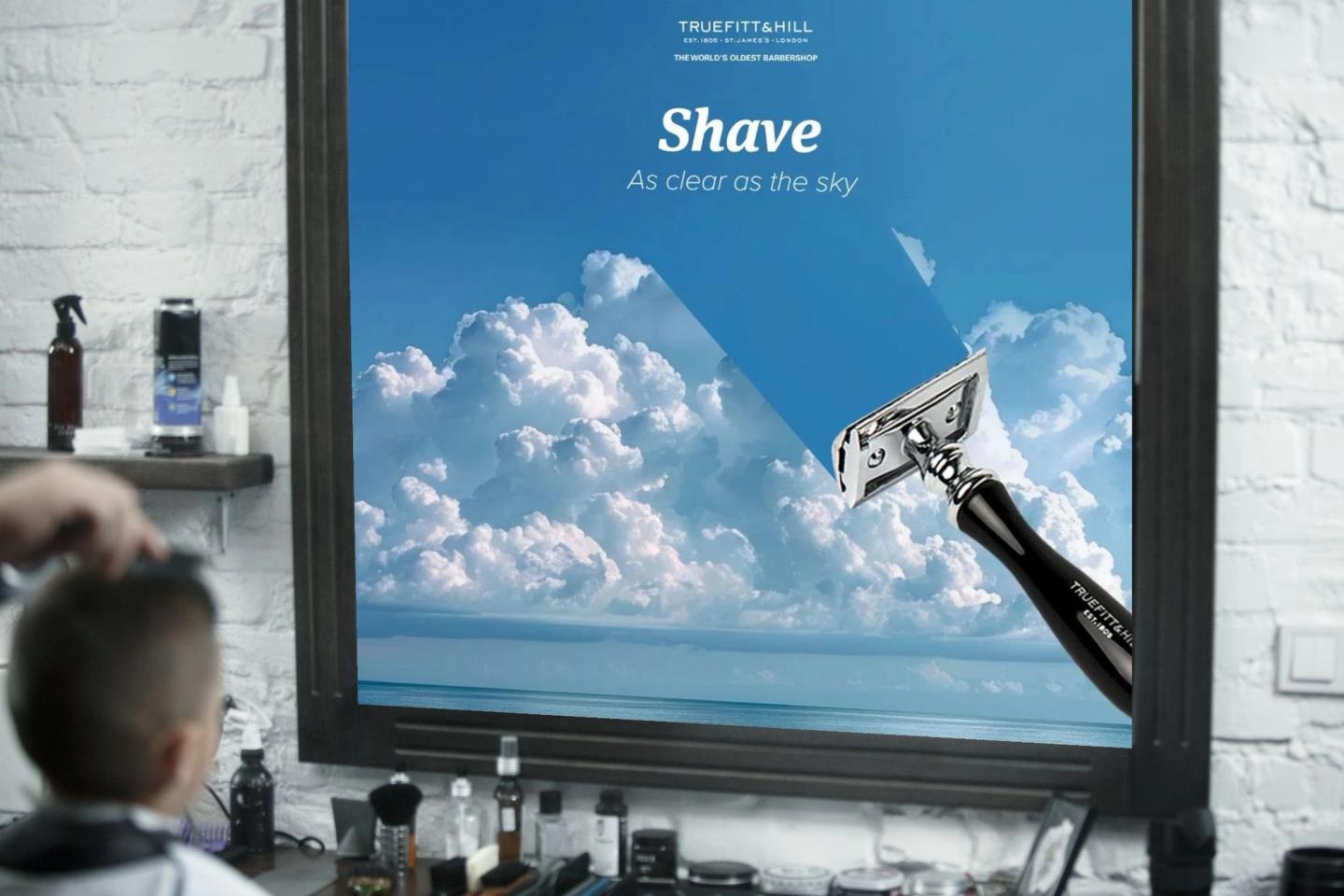 A framed Truefitt & Hill post, Shave, as clear as the sky, a razor against clouds