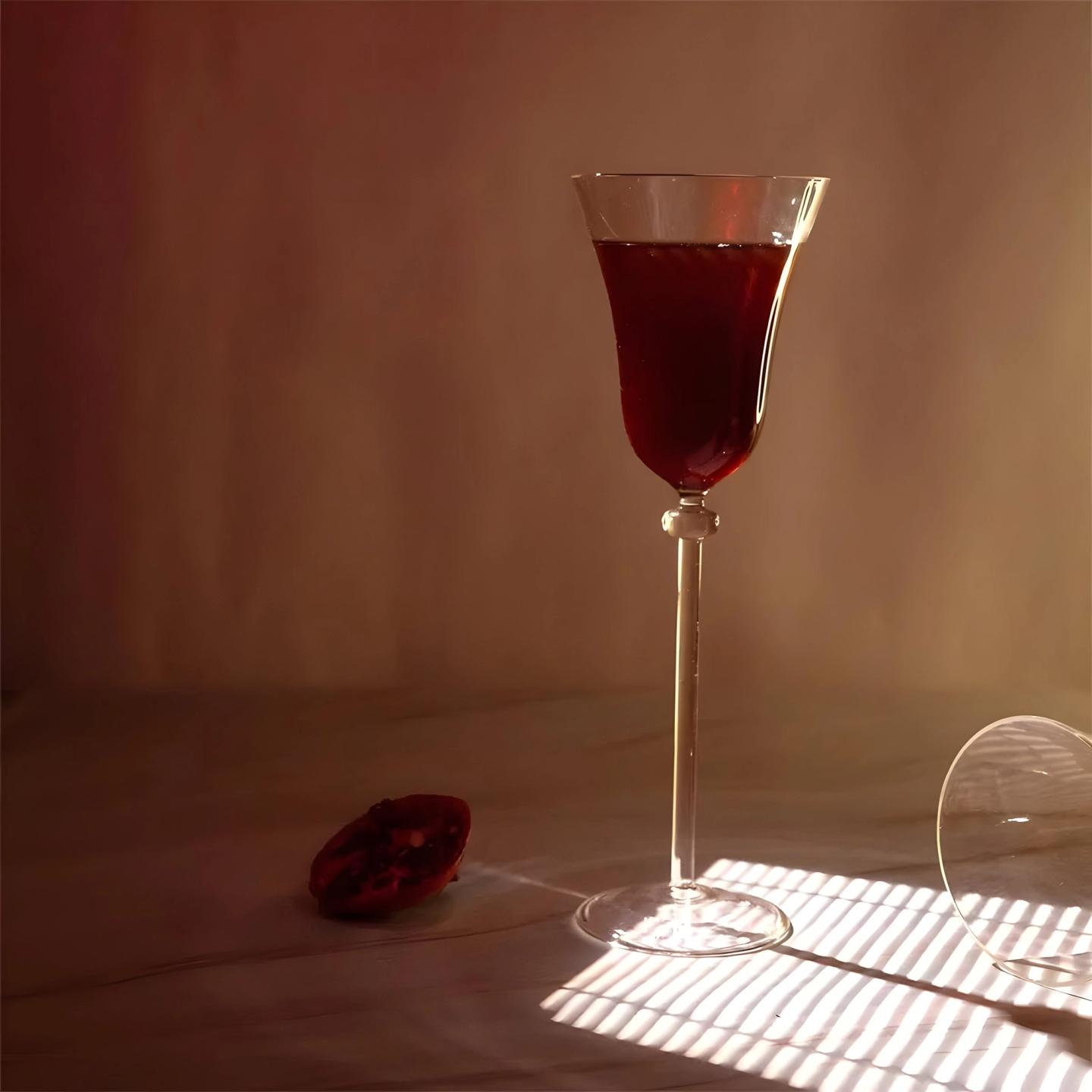 A glass of red wine in a shaft of light