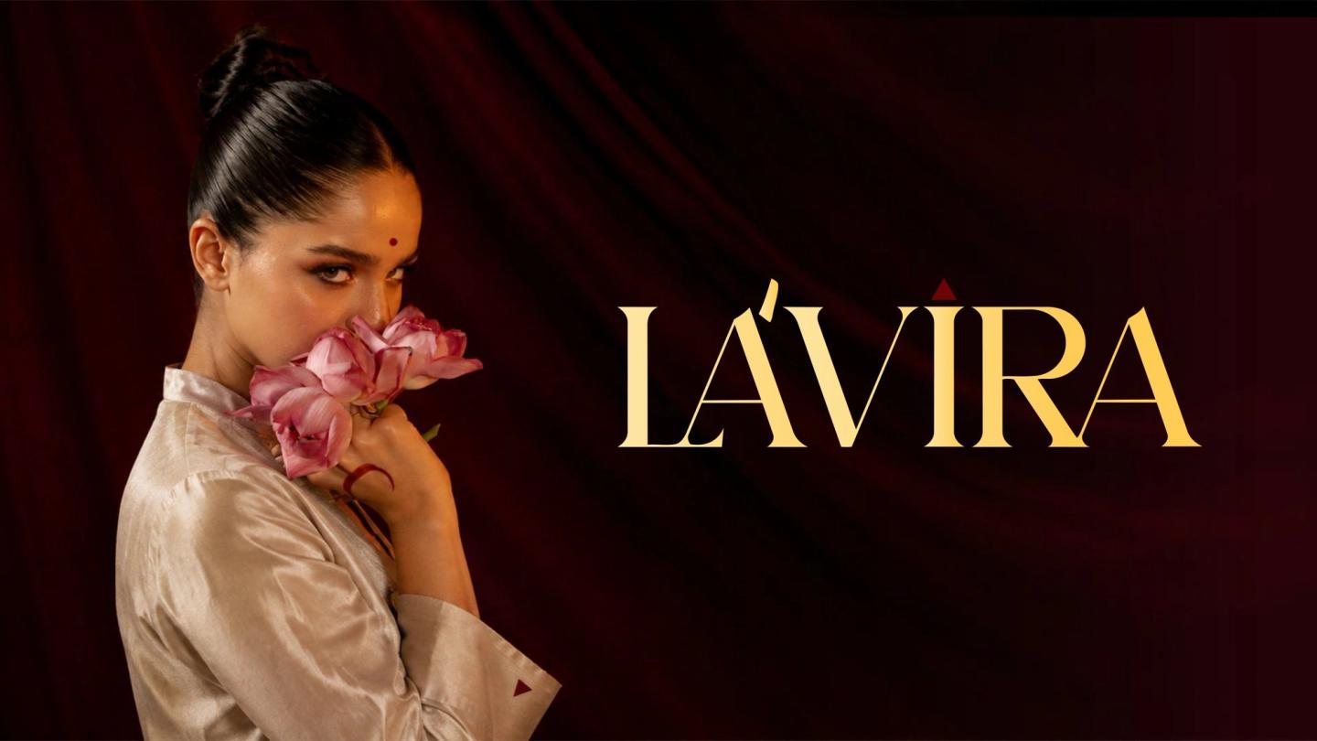 Brandbook cover: a model holding pink lotuses to her face beside the Lávìra wordmark on a maroon drape