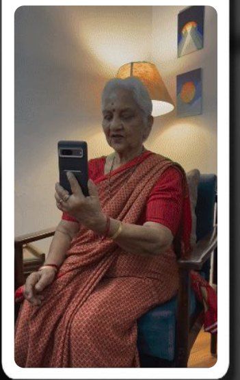 An older woman in a red sari filming herself on her phone