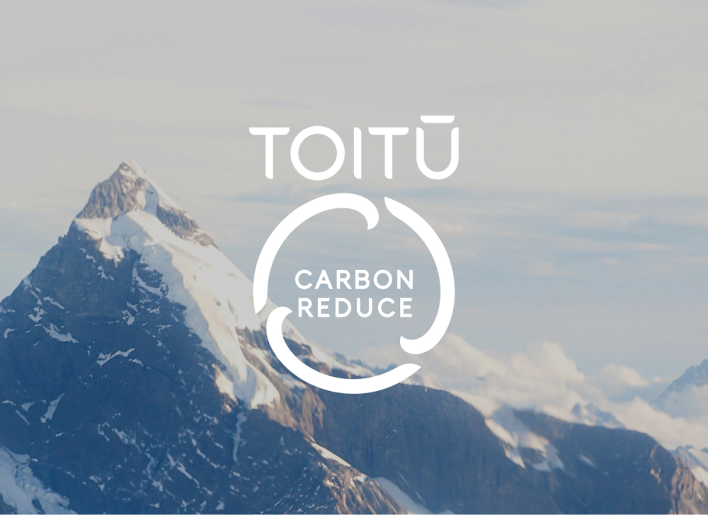 Toitu Carbon Reduce Mark over Mountain Backdrop Toitu Carbon Reduce Mark over Mountain Backdrop
