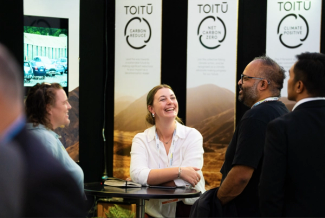 Image shows Toitu team member presenting ICROA approved statis at conference Image shows Toitu team member presenting ICROA approved statis at conference