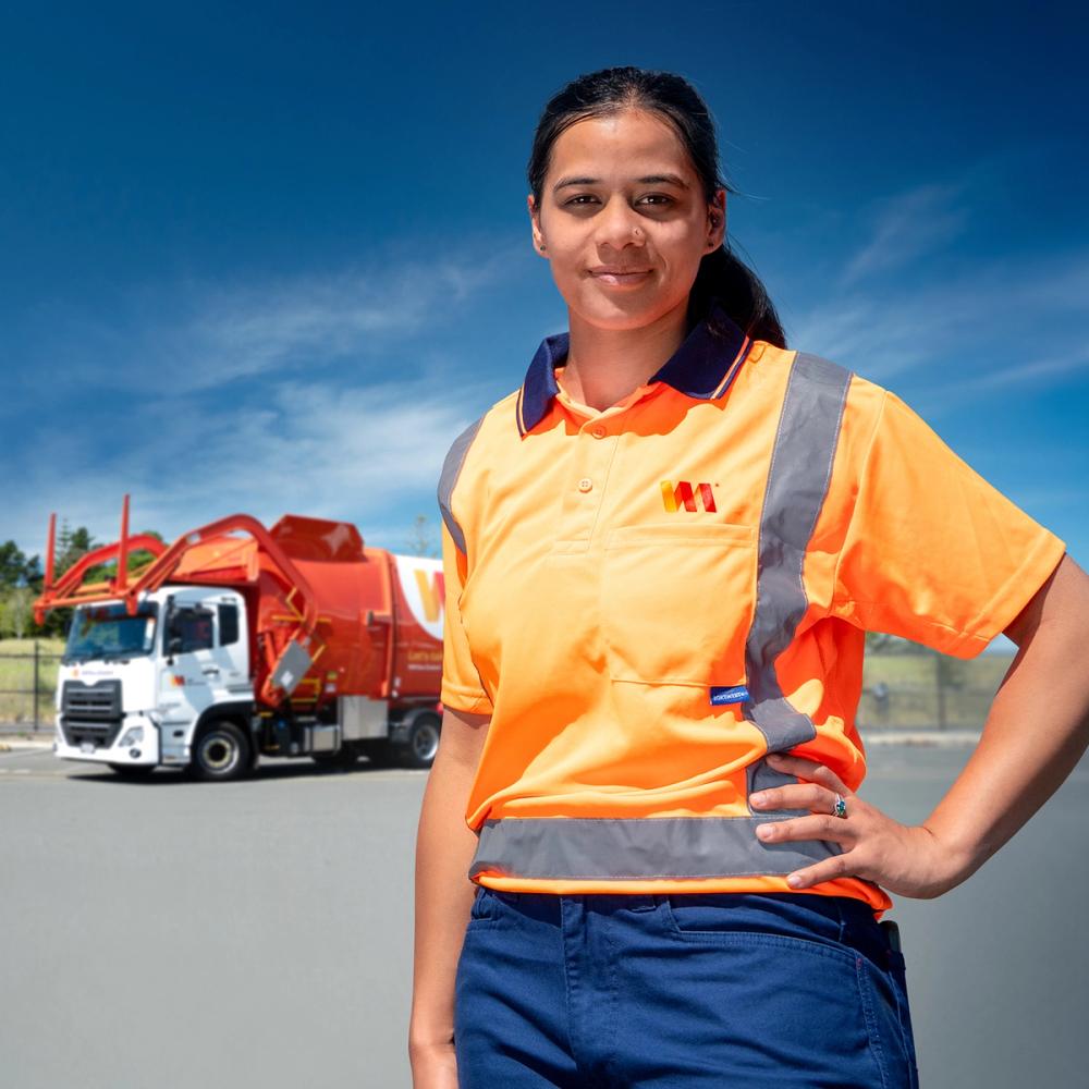 Photo of WM New Zealand engineer in high vis shirt standing proudly in front of waste collection truck Photo of WM New Zealand engineer in high vis shirt standing proudly in front of waste collection truck