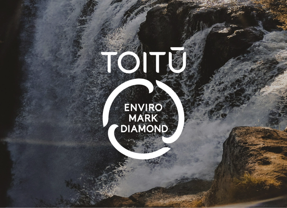 toitu enviromark diamond logo over waterfall backdrop toitu enviromark diamond logo over waterfall backdrop