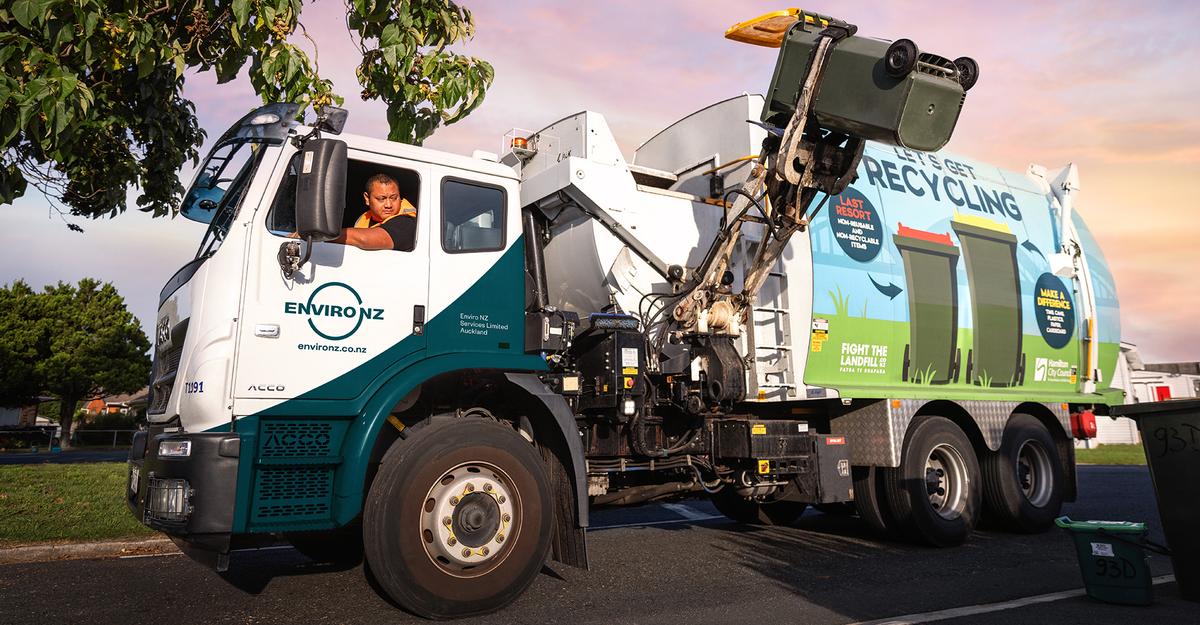 Photo of Enviro NZ truck emptying household bin of recycling