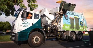 Photo of Enviro NZ truck emptying household bin of recycling