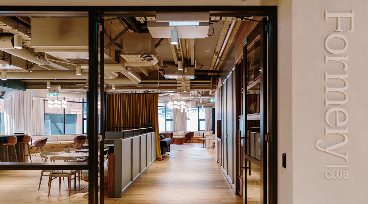 Photo of the Formery club space with warn lighting, wooden floors, and cafe seating Photo of the Formery club space with warn lighting, wooden floors, and cafe seating