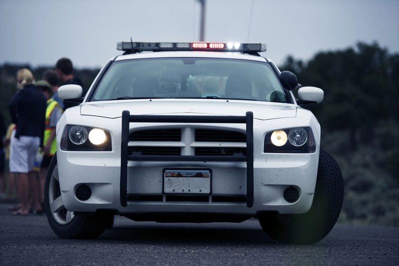 connected police cars and officers