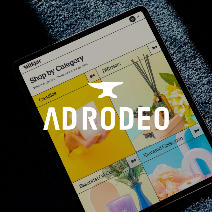 The AdRodeo Gold Anvil award mark over the Milk Jar Candle Co. website shown on a tablet.