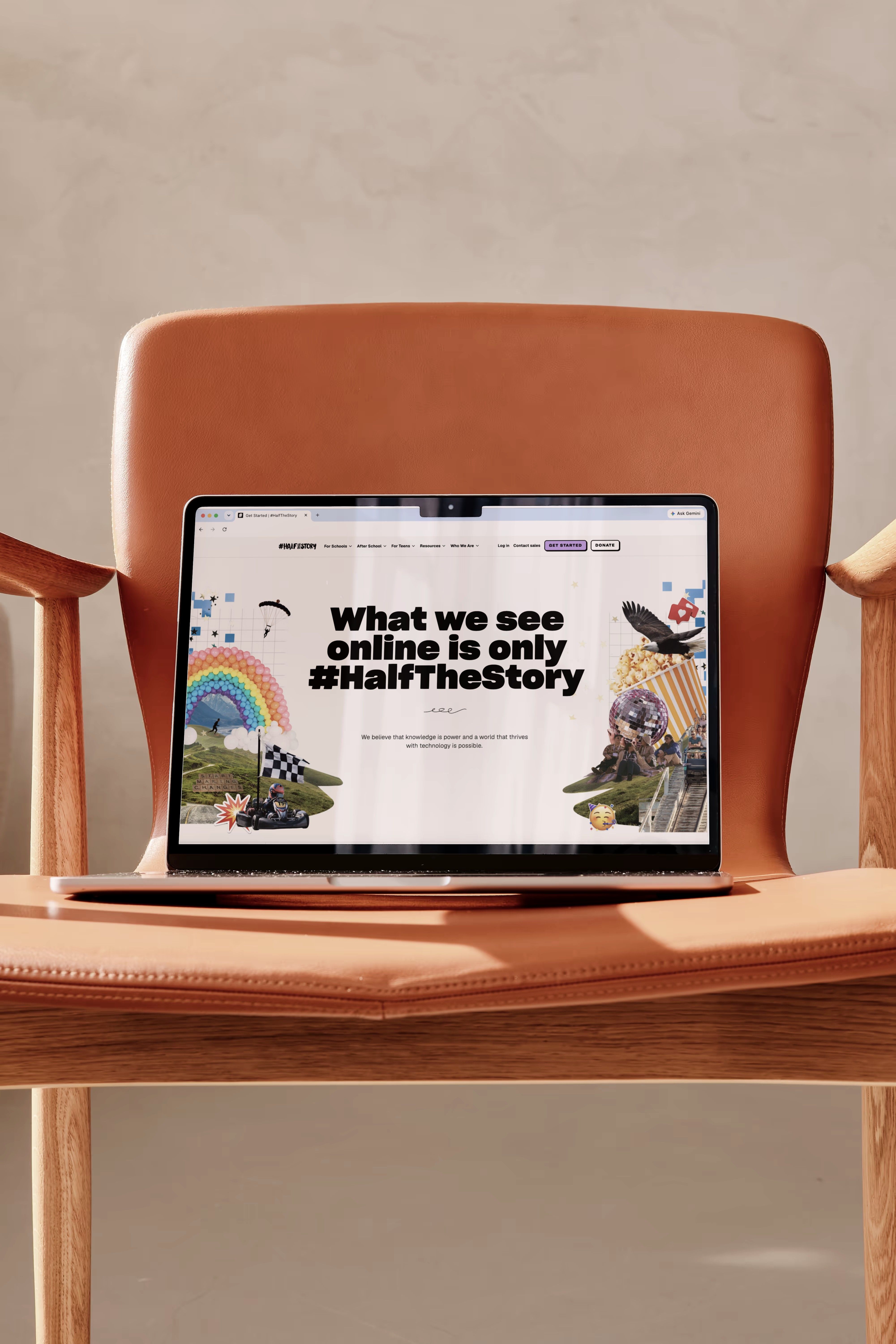 A laptop on a leather chair showing the #HalfTheStory homepage, headed What we see online is only #HalfTheStory.