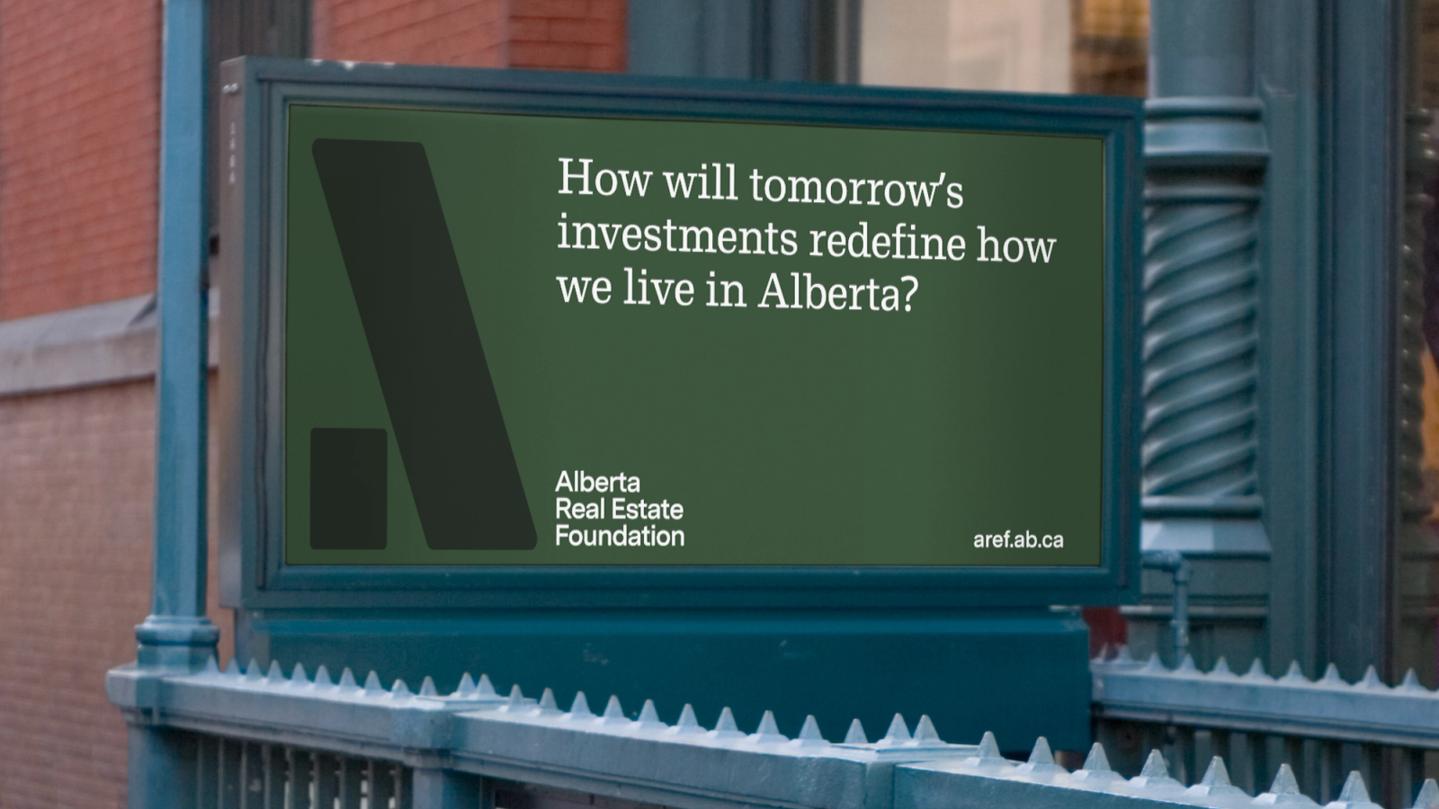 A billboard sign for AREF in green.