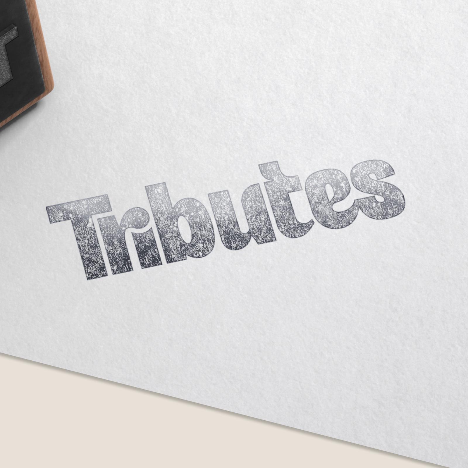 The Tributes wordmark stamped in silver foil on textured white paper.