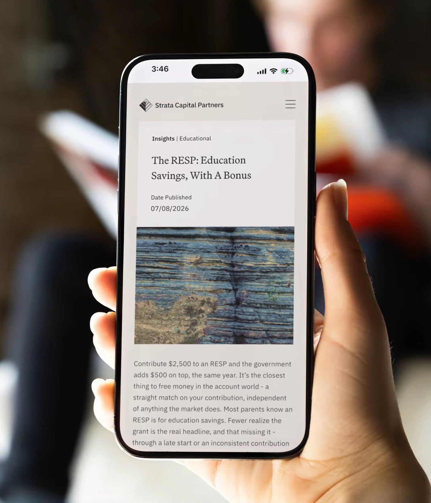 A hand holding a phone that shows a Strata Capital Partners insights article about RESP education savings.