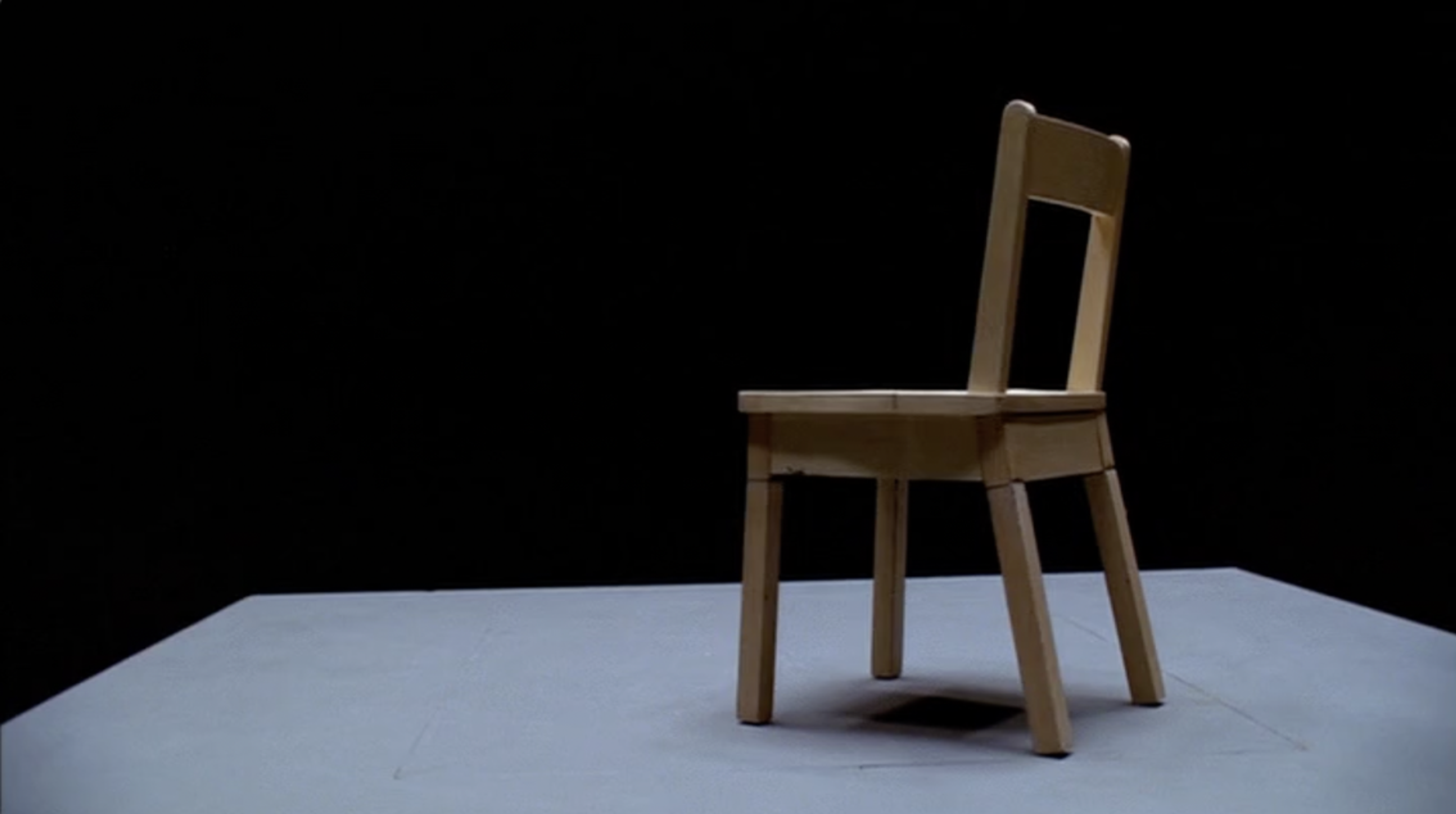 A normal looking wooden chair on a grey floor