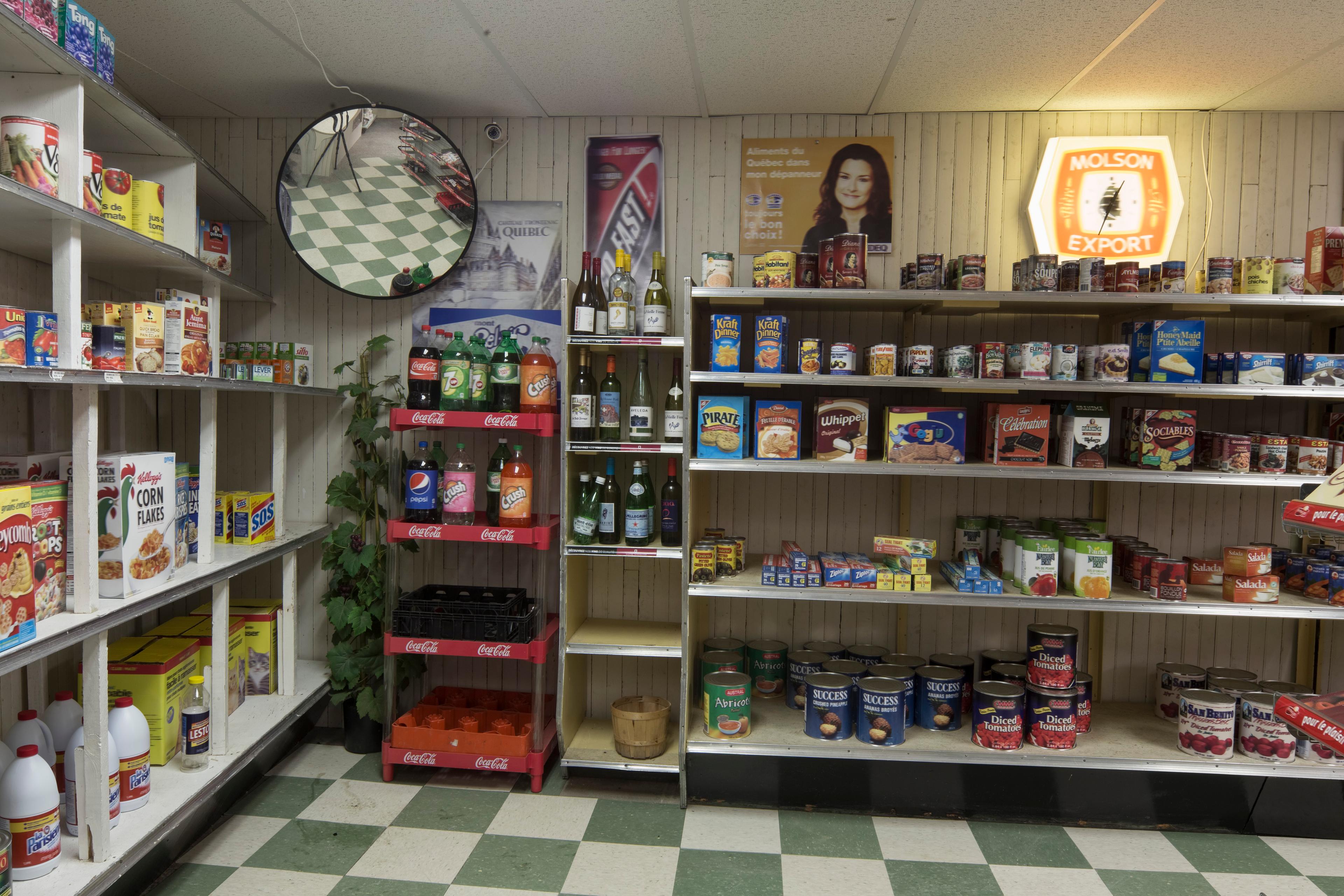 The corner of a convenience store stocked with packaged goods.