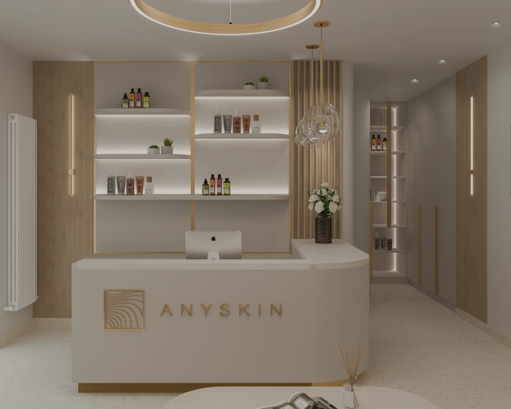 Randare de recepție ANYSKIN cu birou crem, rafturi iluminate cu produse și lustră inelară aurie