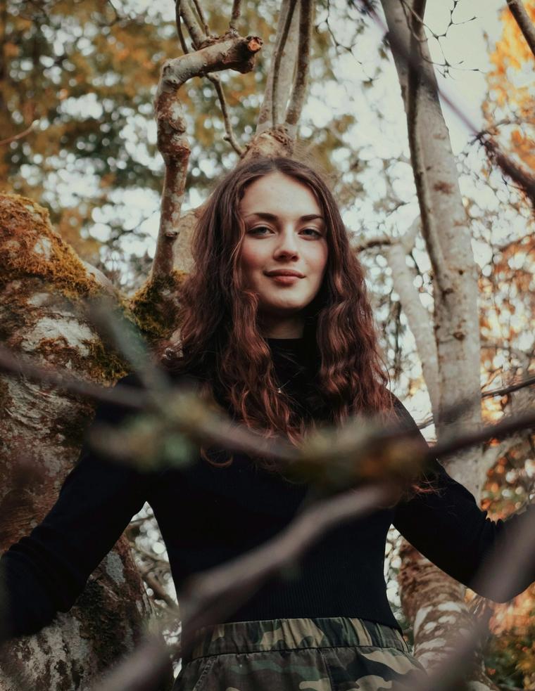 Portrait of a woman among autumn branches