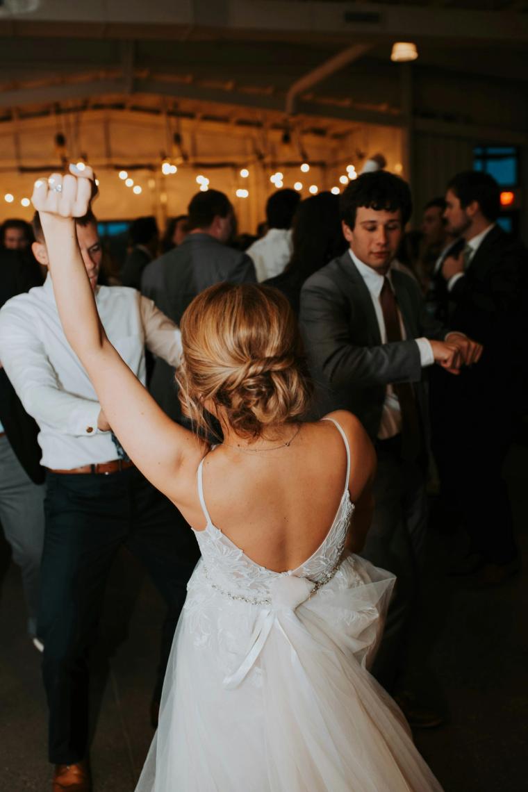 Bride dancing among guests on the reception floor