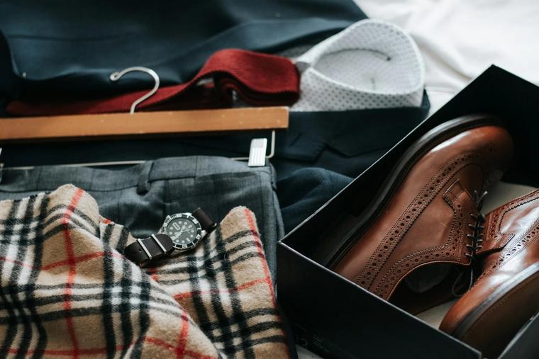 The groom's suit, tie, watch and brogues laid out before the ceremony