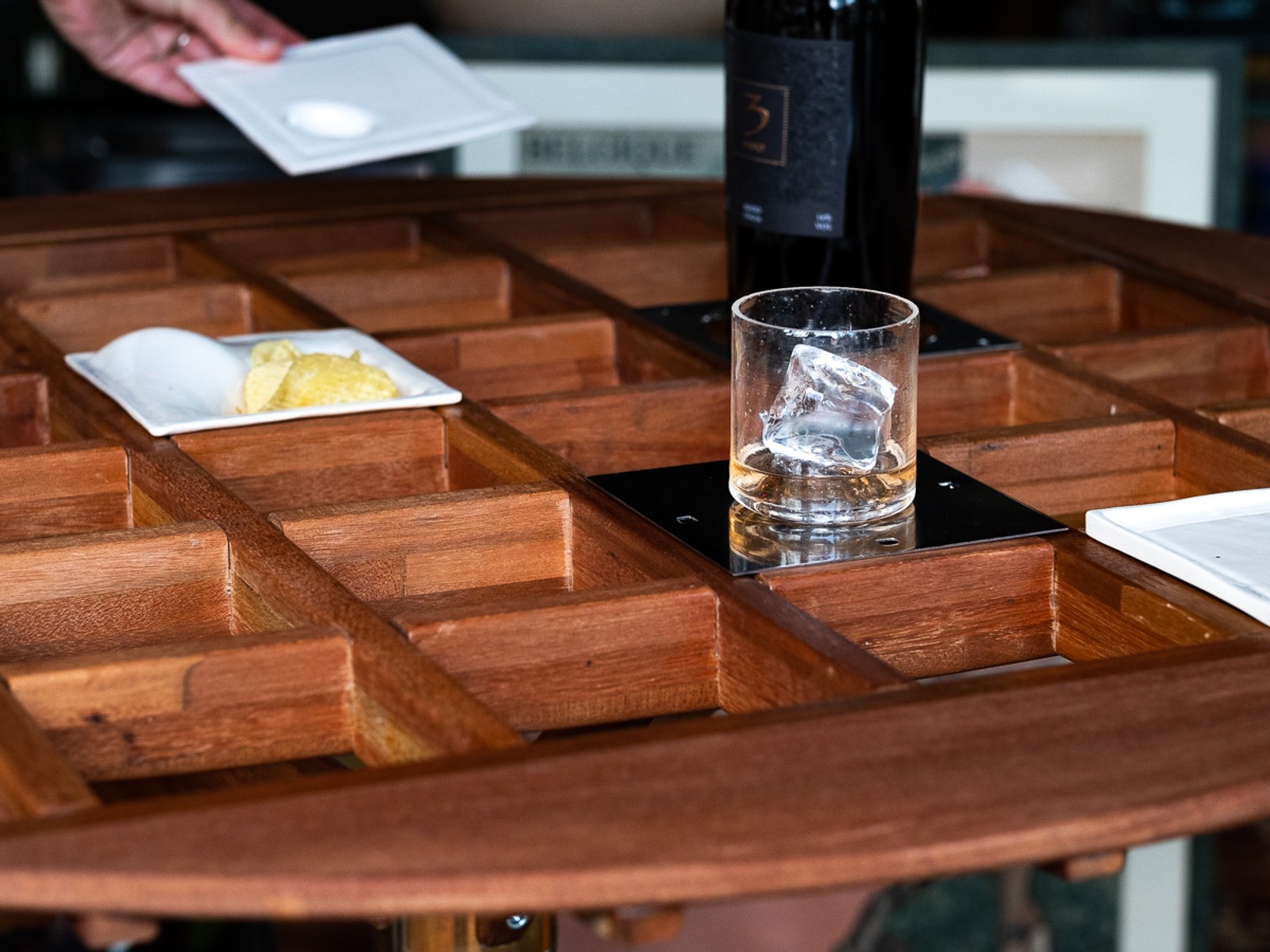 An Audience of Me — detail of the grid holding a chilled drink and a snack plate.