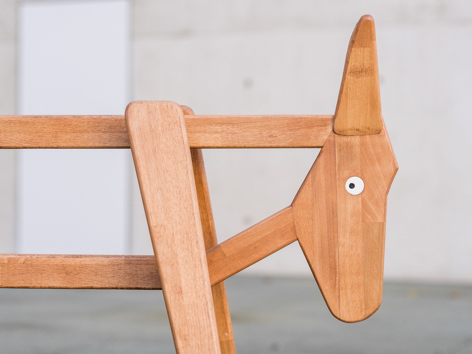 Donkey by NOEMAR — close-up of the joinery where the wooden head and legs meet the frame.